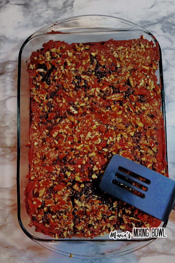 Overhead shot of cake in glass baking dish with spatula laying on top