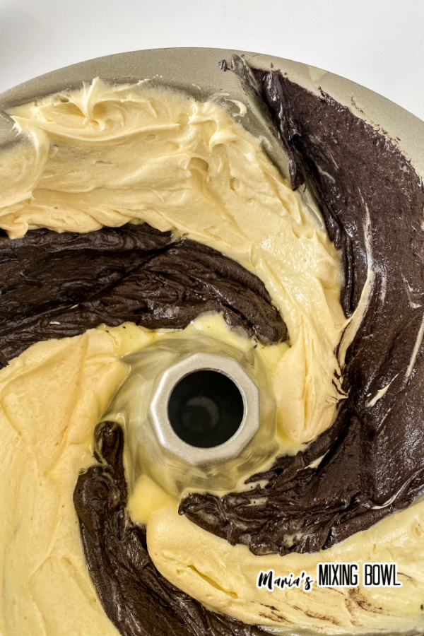 Overhead shot of chocolate and vanilla cake batter swirled in bundt pan
