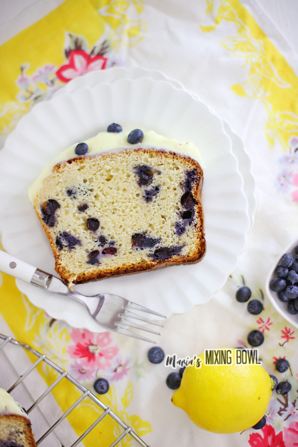 Overhead shot of slice of lemon blueberry ice cream bread on white plate.