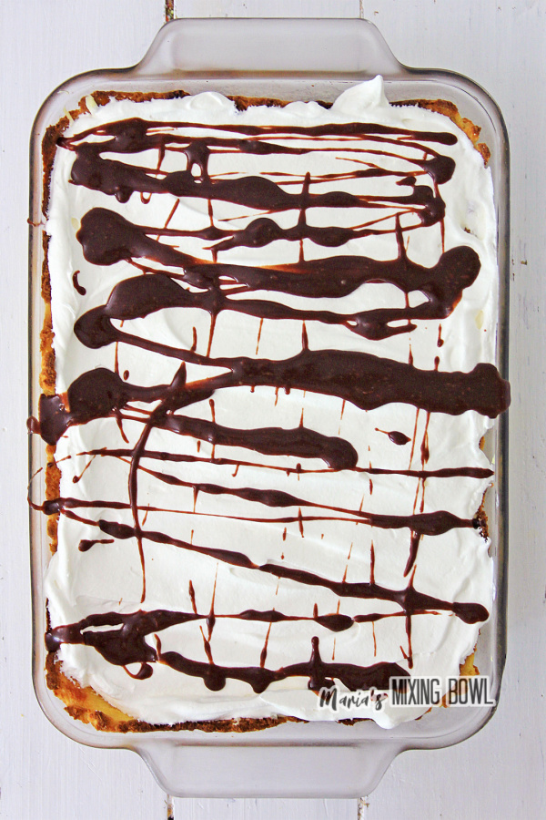 Overhead shot of cream puff cake drizzled with chocolate syrup
