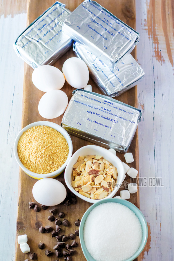 Ingredients for cheesecake recipe on wooden board