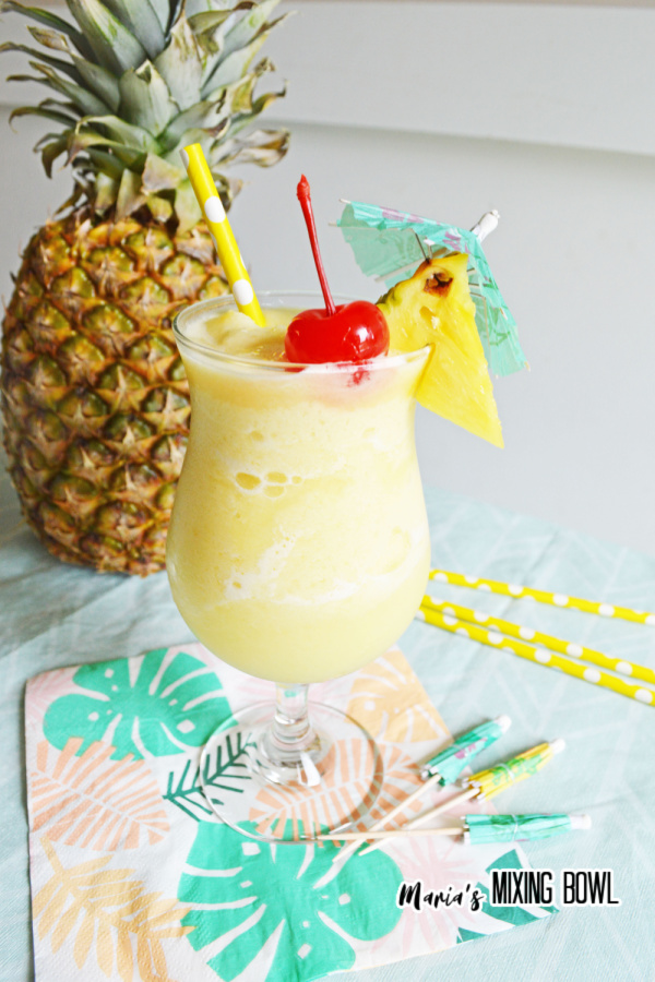 Pina colada in glass with pineapple and cherry