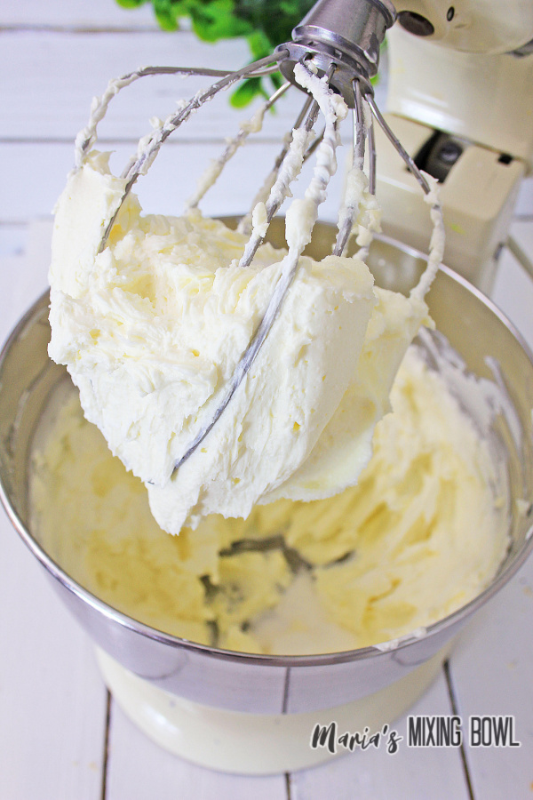 Cheesecake batter being mixed in stand mixer