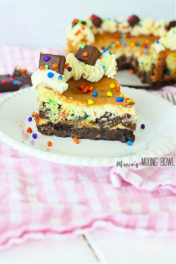 Slice of cosmic brownie cheesecake on plate