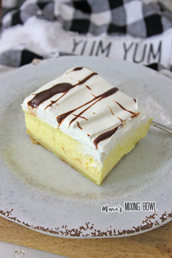 Slice of cream puff cake on white plate
