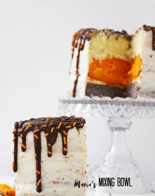 Slice of cake with more cake on cake stand in background
