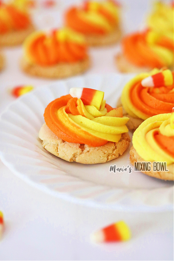 Closeup shot of candy corn sugar cookies on white plate