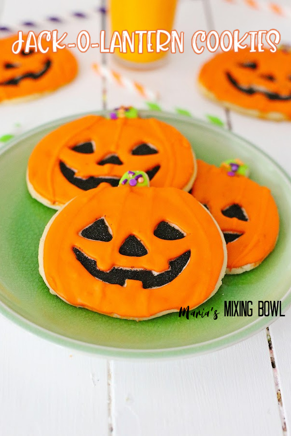 Jack-o-lantern cookies on green plate
