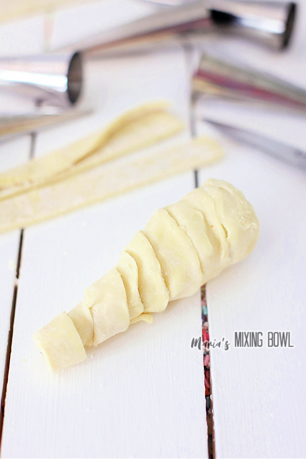 Pastry strips wrapped into Halloween horn