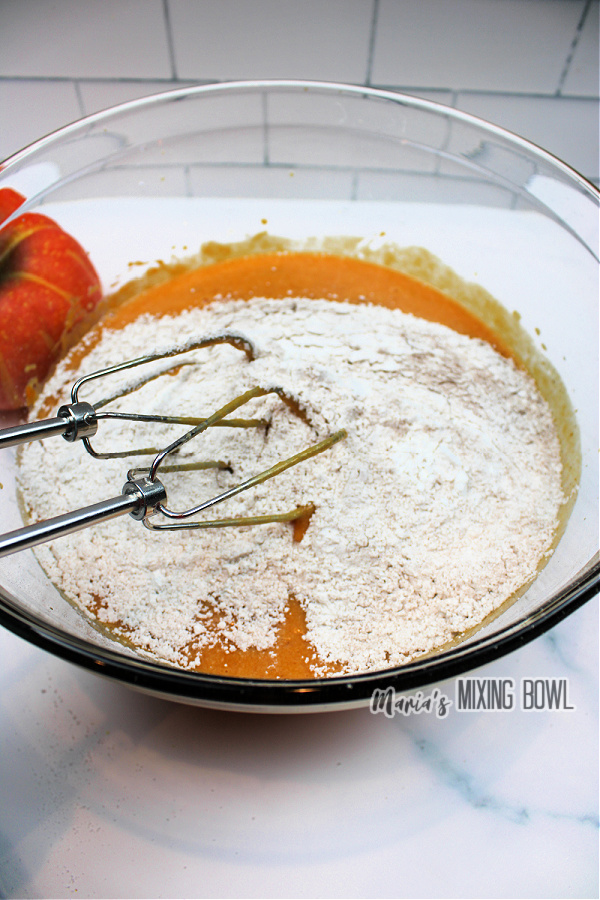 Mixing bowl filled with pumpkin puree and flour