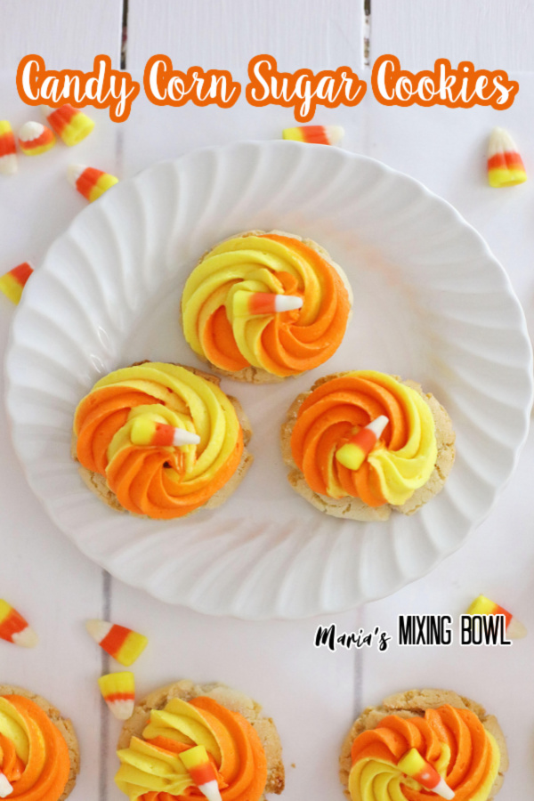 Overhead shot of candy corn cookies on white plate