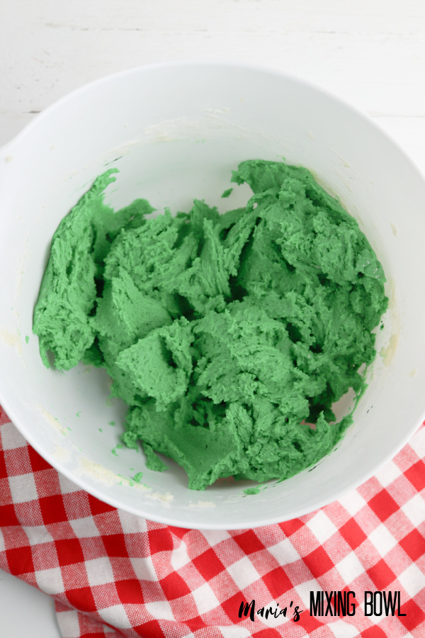 Green cookie dough in white bowl