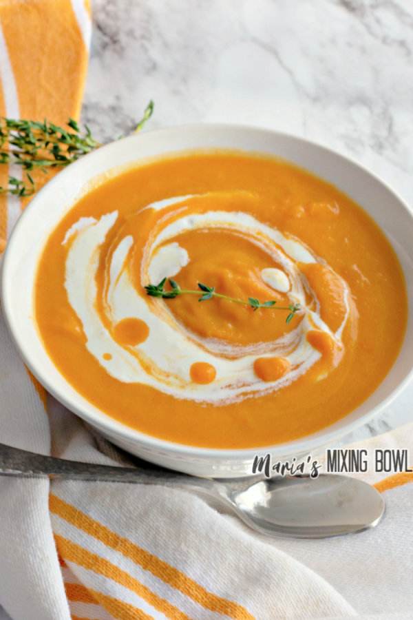 Bowlful of easy butternut squash soup with spoon sitting next to it