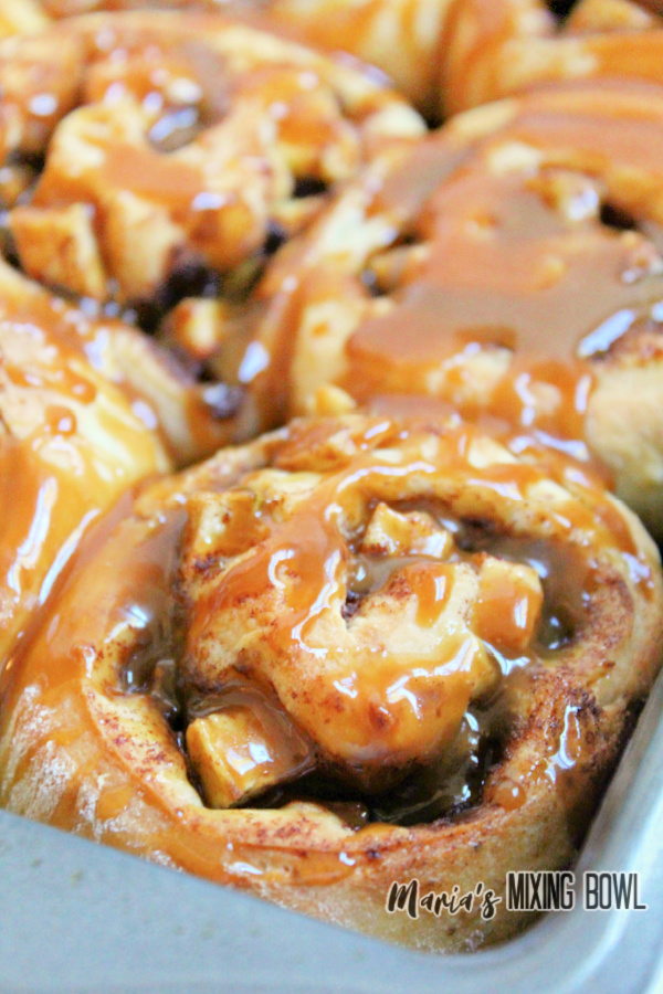 Closeup shot of caramel apple cinnamon rolls in baking dish