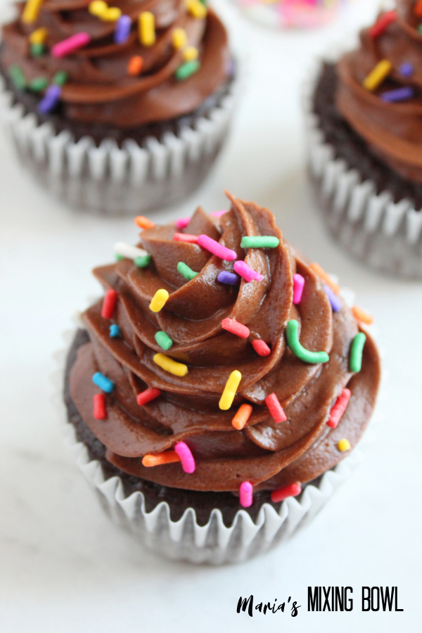 Closeup shot of double chocolate cupcake with more cupcakes in background