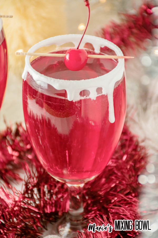Santa cocktail in stem glass with red garland