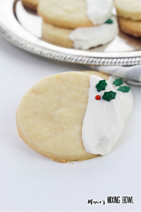 Christmas Shortbread Cookies with a silver tray of cookies in background