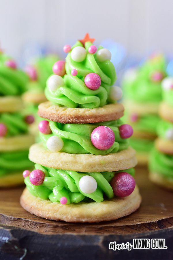 Closeup shot of frosted Christmas tree cookies on board