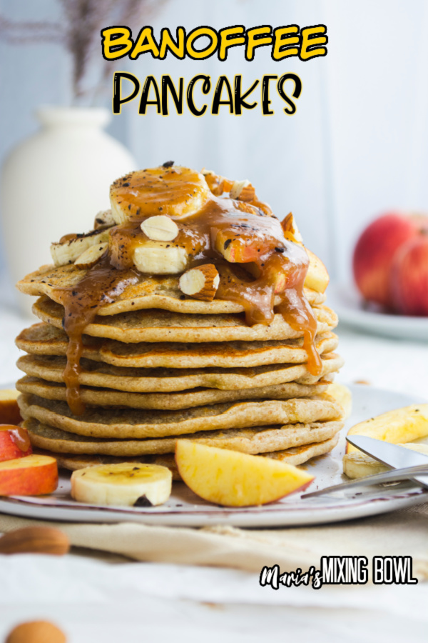 Stack of banoffee pancakes topped with banands and caramel on plate