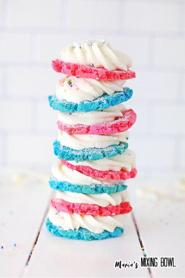 Stack of blue and pink birthday cake sugar cookies stacked atop on another