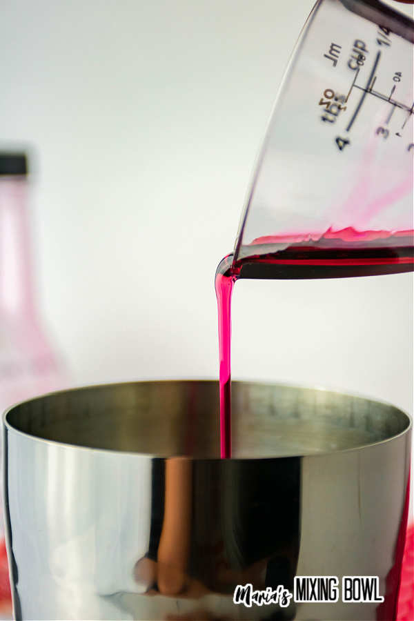 Grenadine being poured into shaker
