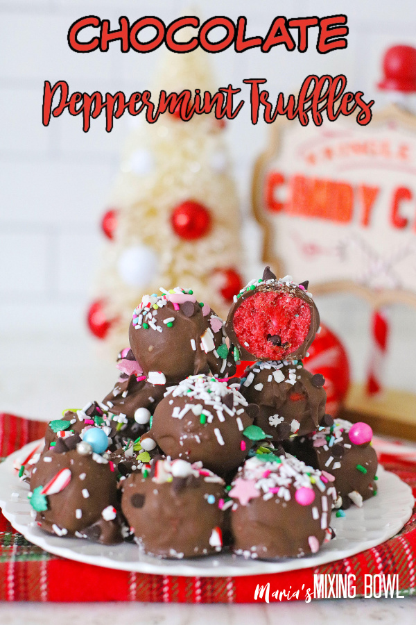 Stack of chocolate peppermint truffles on plate with top truffle cut in half