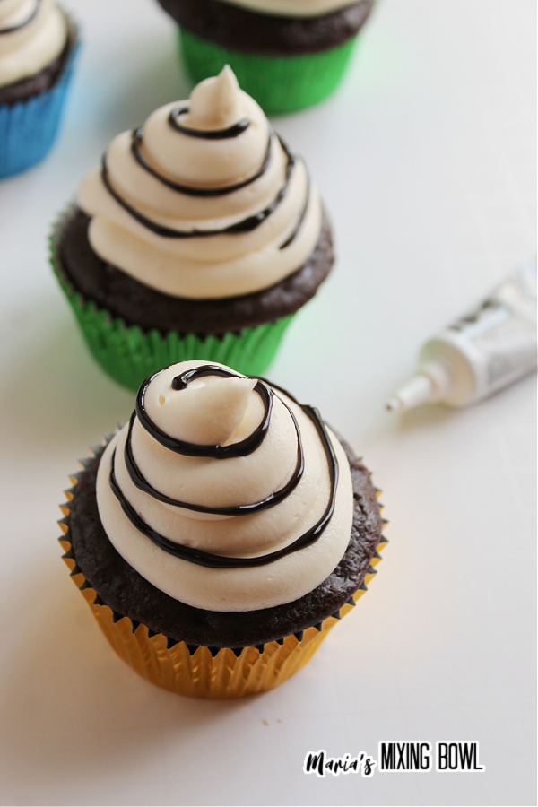 Frosted chocolate cupcakes with gel food coloring swirl