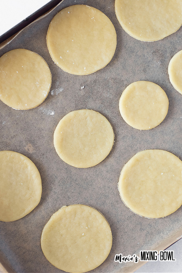 Overhead shot of raw cookies in various sizes on baking sheet