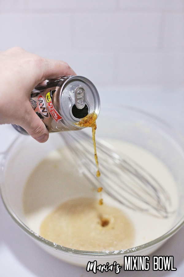 Can of root beer bing poured into batter mix in bowl