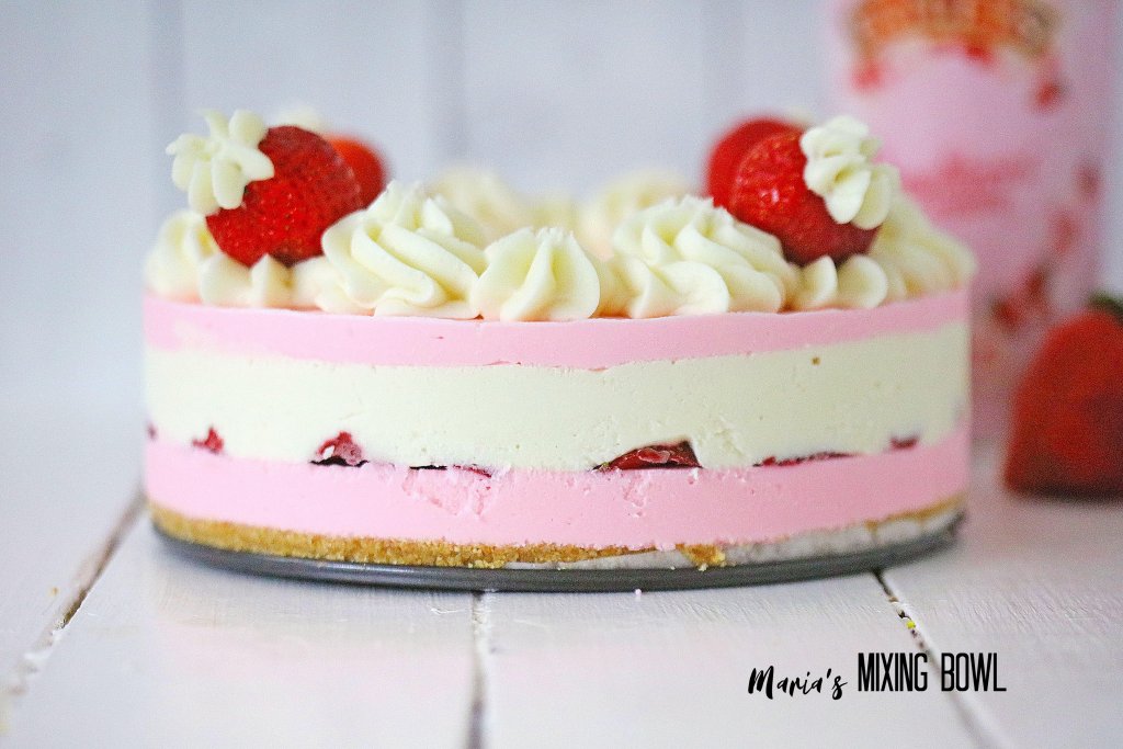 Whole strawberries and cream cheesecake on cake wheel