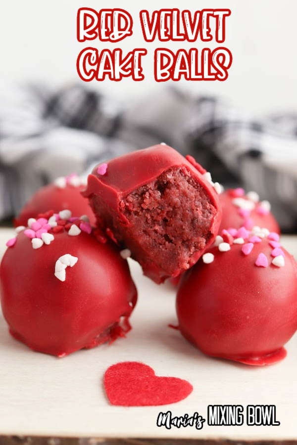 Closeup shot of red velvet cake balls with bite taken out of one cake ball. 