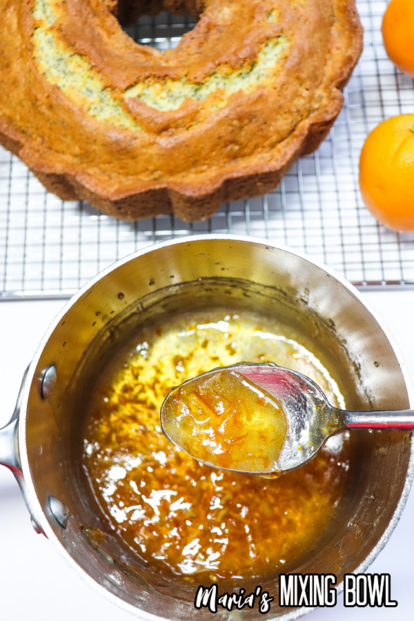 Overhead shot of spoonful of marmalade over pot with more marmalade