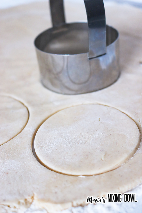 Closeup shot of cookie cutter cutting out sugar cookies