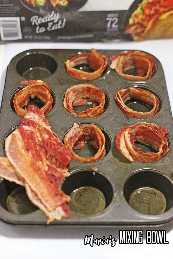 Bacon being placed around the interior of mufin tin