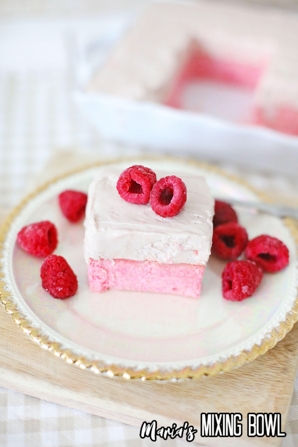 Raspberry cheesecake dessert on white and gold plate 