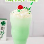 Shamrock Shake in a tall glass with a cherry on top and a straw