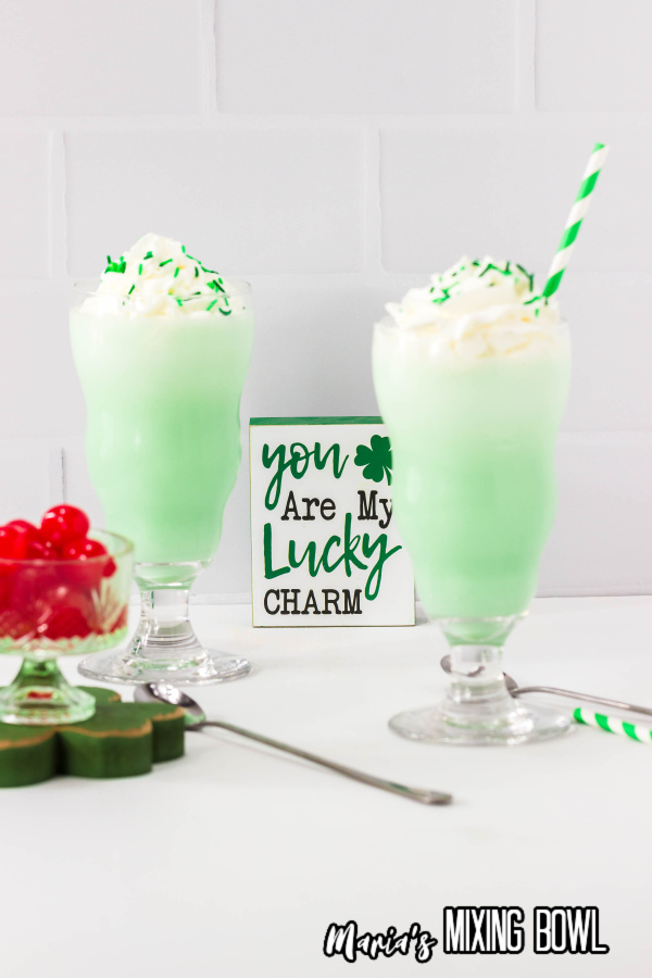 2 Shamrock shakes with sprinkles and a bowl of maraschino cherries