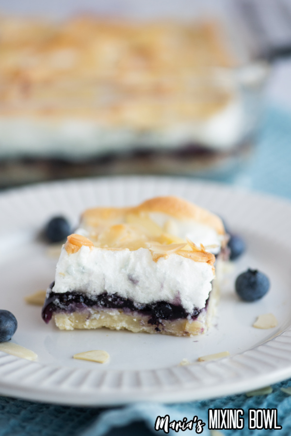 a slice of baked blueberry square on a white dish