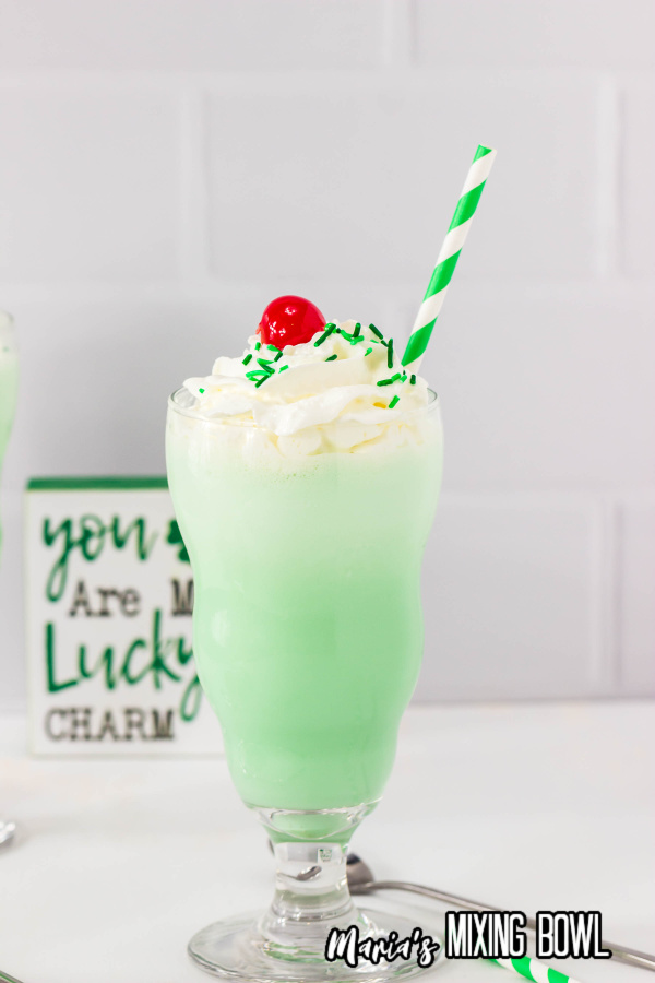 Shamrock Shake with whipped cream cherry on top green and white straw