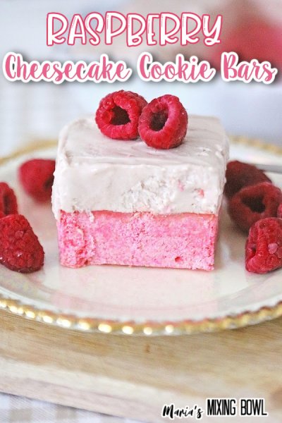 Raspberry Cheesecake Cookie Bars on a white plate with raspberries on top on on either side