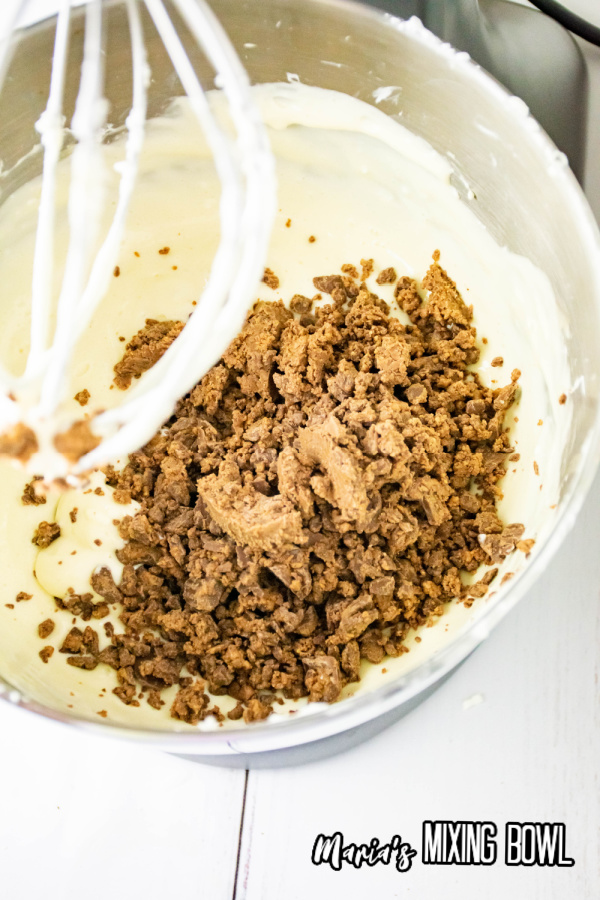 Cheesecake ingredients being added to mixing bowl