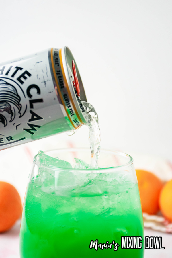 topping off green screwdriver with hard seltzer