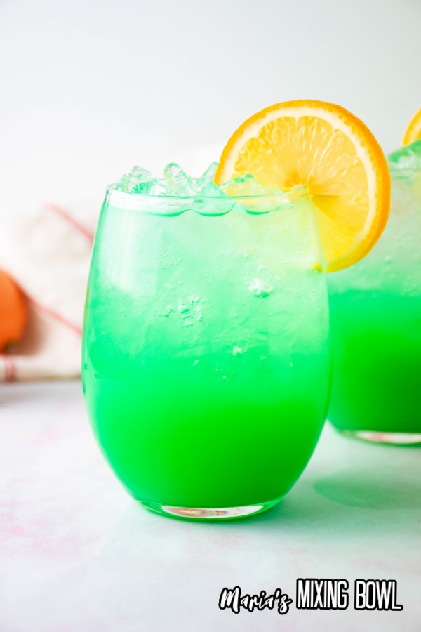 green drink with orange garnish