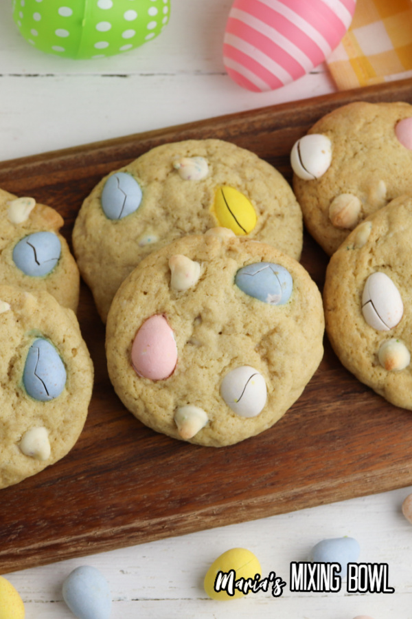 Easter Mini Egg Cookies on a board with plastic Easter eggs
