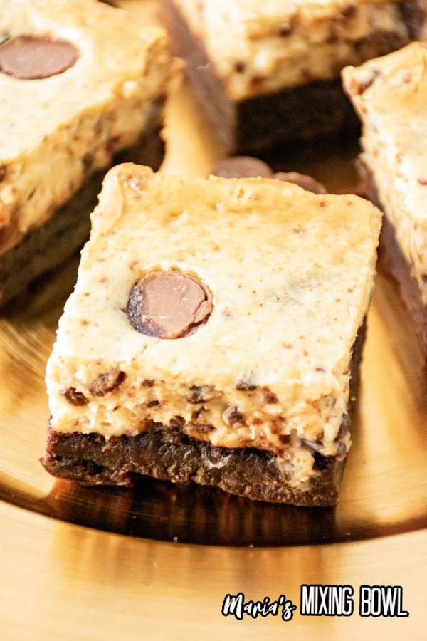 Closeup shot of cheesecake brownie bars on cutting board