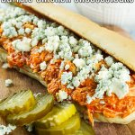 Slow Cooker Buffalo Chicken Cheesesteaks onboard with pickles and blue cheese