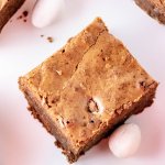 Mini Cadbury Egg Brownies on a white plate with mini chocolate eggs