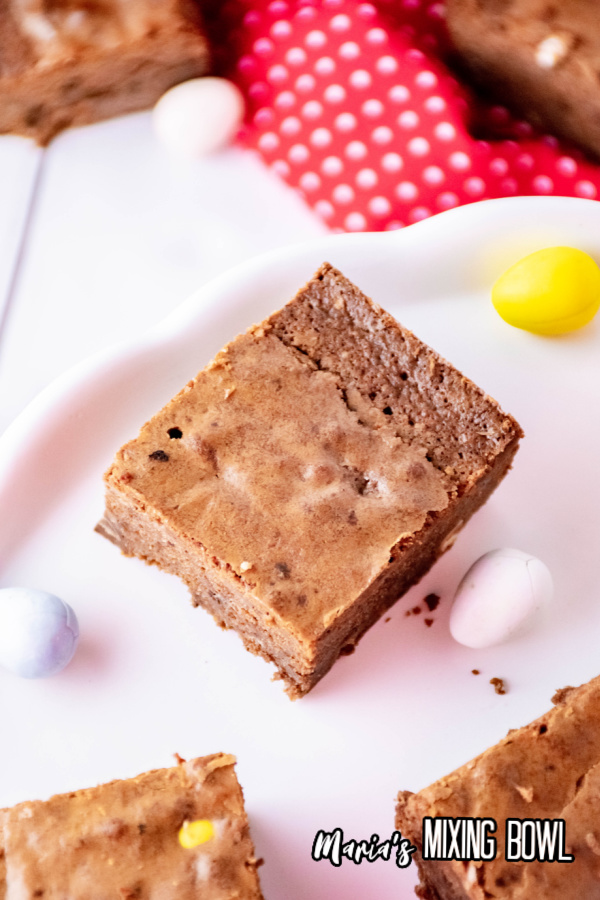 brownies with mini cadbury eggs on a platter and red and white napkin