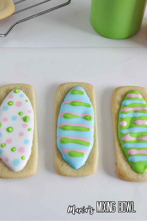 Overhead shot of three Easter sugar cookies decorated to look like eggs