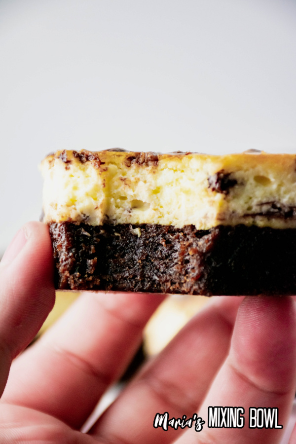 a bite of a cheesecake brownie